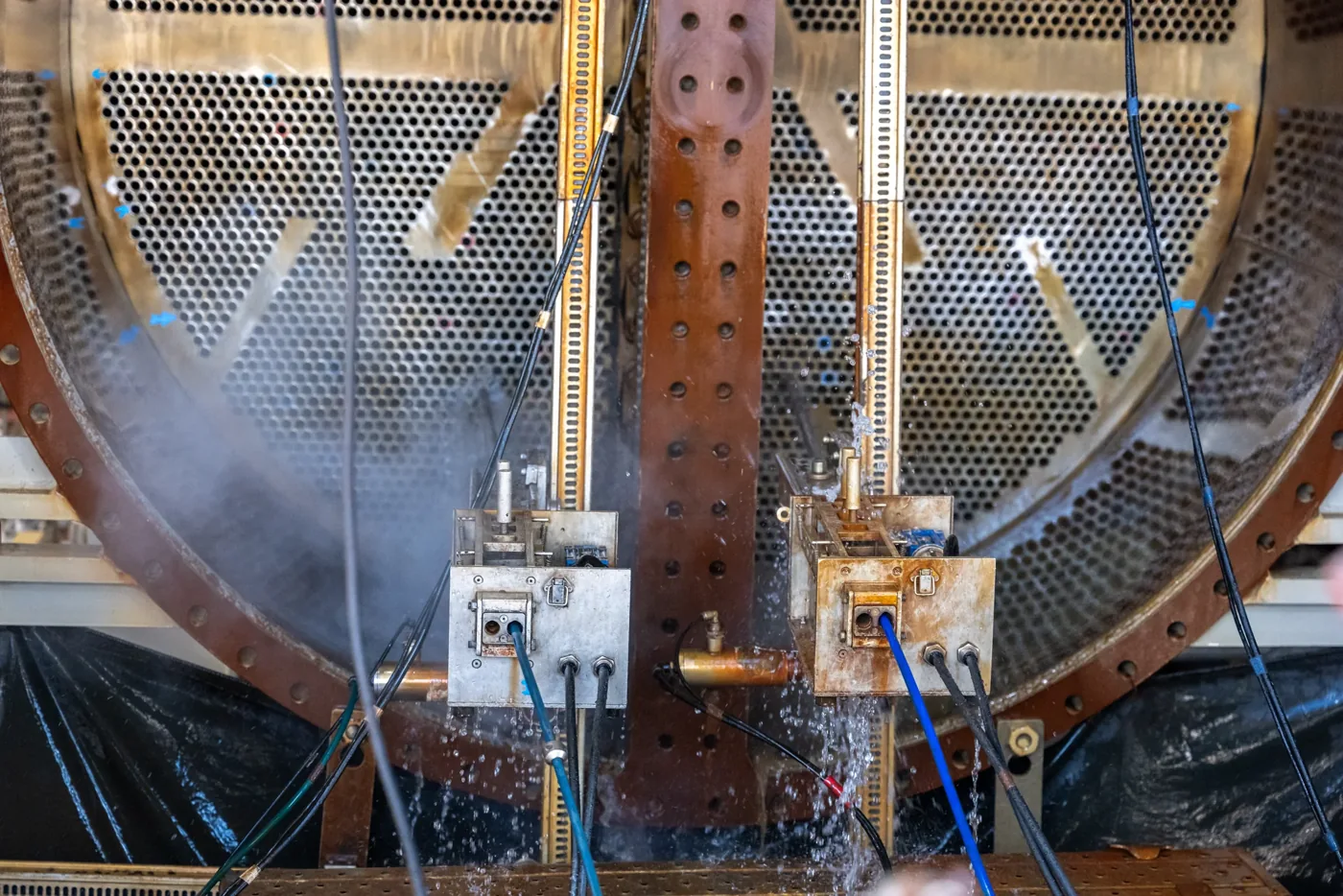 Tube-cleaning equipment positioned against the tube plate of a large heat exchanger.