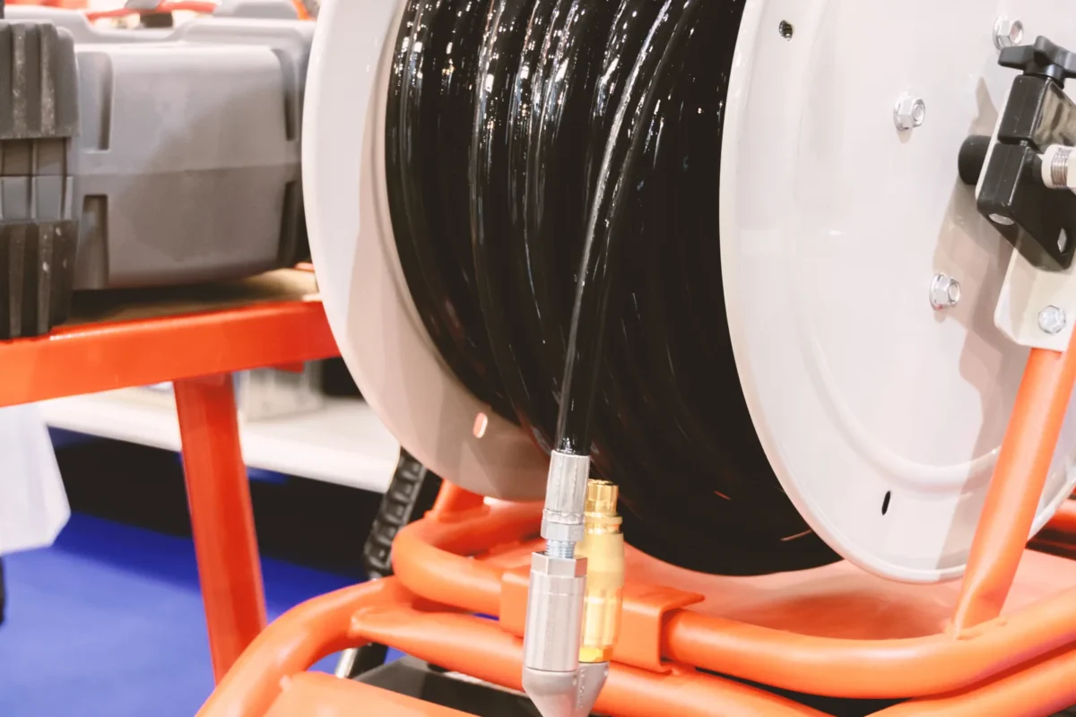 A hose reel and connection on specialist drain-cleaning equipment.