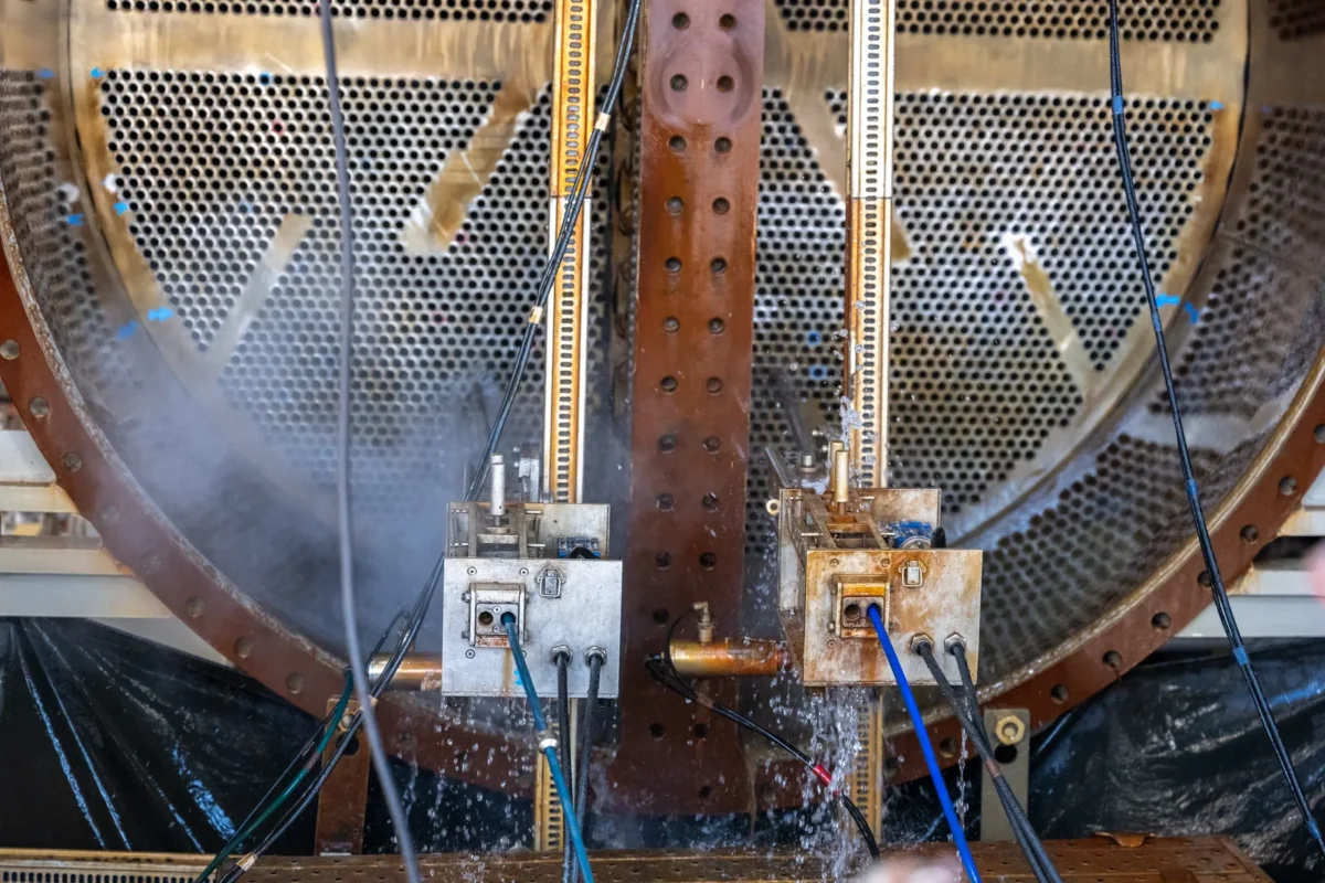 Tube-cleaning equipment positioned against the tube plate of a large heat exchanger.